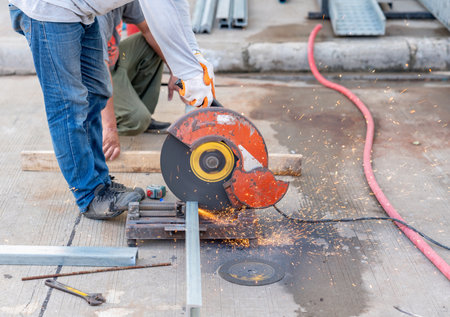 Worker cutting steel with fiber machine for use factory roof structure.Industry in construction site conceptの写真素材