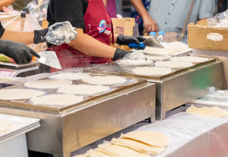 Hot crepes in a pan on a hot pan in the street market.の写真素材