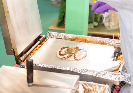 Crispy dried soft shell crab on hot pin pan in street market.の写真素材