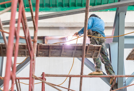 Worker welding beam at hight building without safty device ptotection.の写真素材