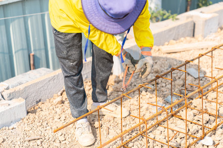 Cutting nipps steel fixer pliers holding on construction worker hand while his hand wear a gloves.の写真素材