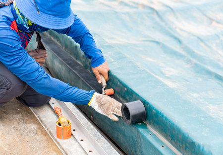 Worker use roller compress rubber gasket on edge of waste water dome.の写真素材