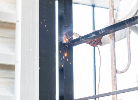 Worker welding structure at hight on factory.の写真素材