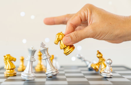 Businessman moving chess piece and checkmate during competition. Successful business competition concept.の写真素材