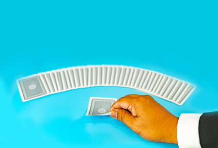 Close up business man's hand flip playing card on aqua background , concept of business take a chance for success.の写真素材