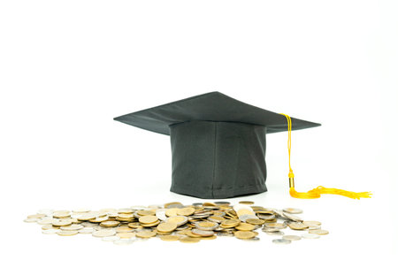 Pile of money coin with graduation cap isolate on white background. Concept of study invesment, financeの写真素材
