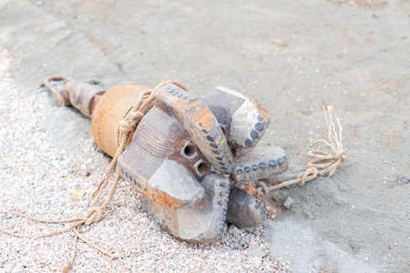 Close-up of a heavy-duty, threaded rock drill bit (button bit) with tungsten carbide inserts, designed for use in rotary or top hammer drilling equipment.の写真素材