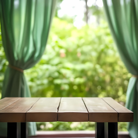 Empty wood table top on blur abstract garden and house background. For montage product displayの素材