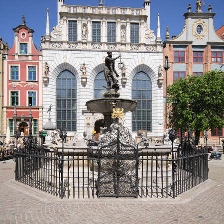 Danzig, Poland - May 13, 2009: Historic Neptune Weel with fountain in ancient marketplace and Artus Court behind it.のeditorial素材