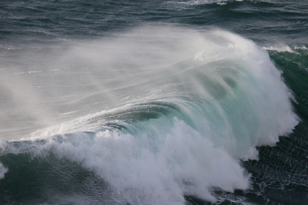 Powerful waves of Atlantic Ocean and stormy wind at Ponta de Sagres, South West of Portugal