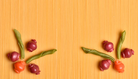 Frame from macaroni. Texture from colored macaroni. Italian cuisine. National food of Italy. Assortment of pasta. Food program. Produce with flour.の写真素材