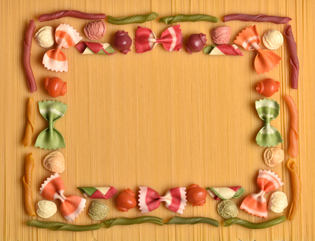 Frame from macaroni. Texture from colored macaroni. Italian cuisine. National food of Italy. Assortment of macaroni. Food program.の写真素材
