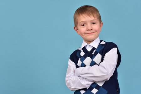Portrait of a boy on a blue backgroundの写真素材