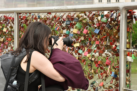 Austria Salzburg. April 29, 2018. The girl is taking pictures. A tourist in the city.のeditorial素材