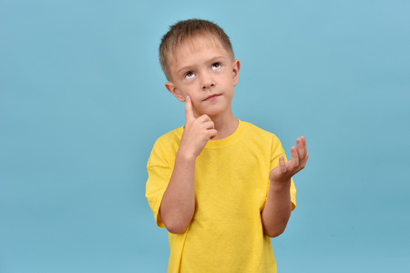 The boy in a yellow T-shirt. Thoughtful teenager.の写真素材