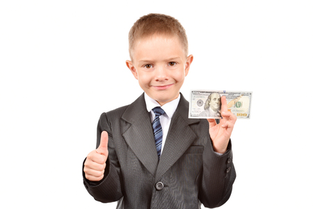 The boy holds dollars. Young businessman on a white background.の写真素材