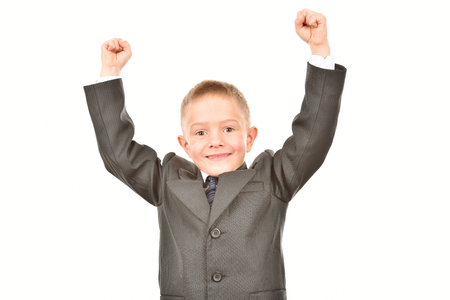 Boy in a suit on a white background. Happy childhood. Young businessman.の写真素材