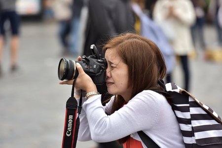 France Paris May 2, 2018. A girlfriend takes pictures of the streets of Paris.のeditorial素材