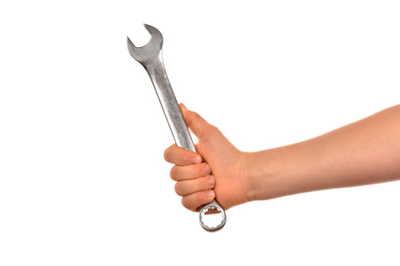 Man's hand holds a wrench isolated on white background.の写真素材