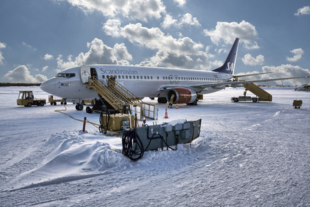 SWEDEN, KIRUNA AIRPORT - FEBRUARY 26, 2012: SAS Scandinavian airlines airplane during last control procedures before departure. Snow condition.のeditorial素材