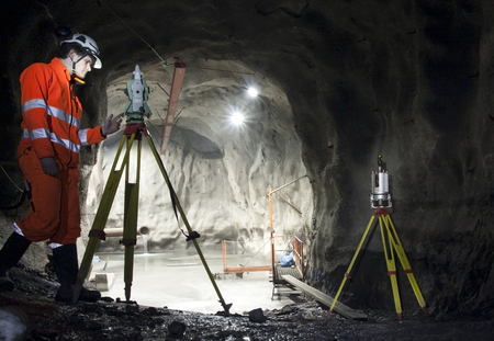 SWEDEN, KIRUNA IRON ORE MINE - FEBRUARY 26, 2012: A land surveyor during his work with surveying and...