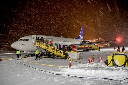 SWEDEN, KIRUNA AIRPORT - JANUARY 12, 2012: SAS Scandinavian airlines airplane shortly before departure. Snow storm.のeditorial素材
