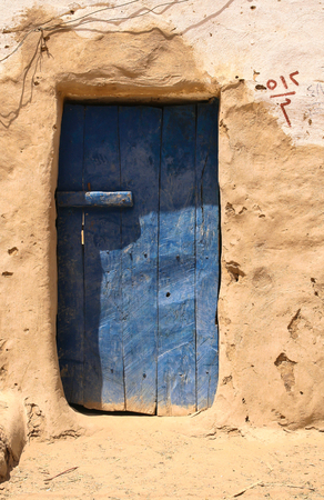 A traditional blue wooden door in the fortified Islamic town of Al Qasr was built at Dakhla Oasis in the 12th century, Dakhla, Egyptの写真素材