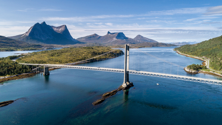 Aerial shot of a suspension bridge over Efjord with  mountain Stortinden in the background, Ballangen, Norwayの写真素材