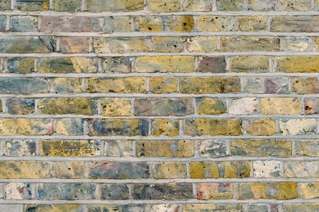 Colorful old brick wall in London. Blue and yellow.の写真素材