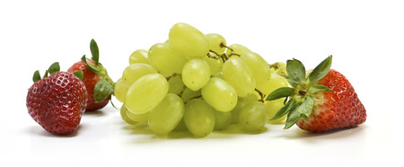 Fruit - grapes, strawberries and apple on a white backgroundの写真素材