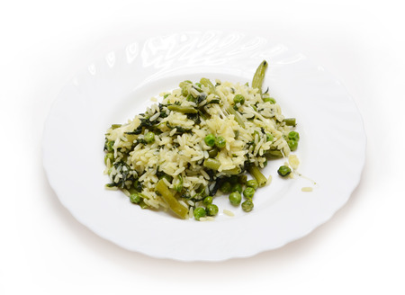 Rice, peas, spinach, green beans and cheese on white plateの写真素材