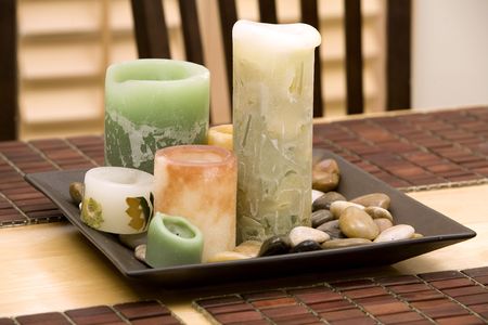 beautiful candles decoration with rocks on the tableの写真素材