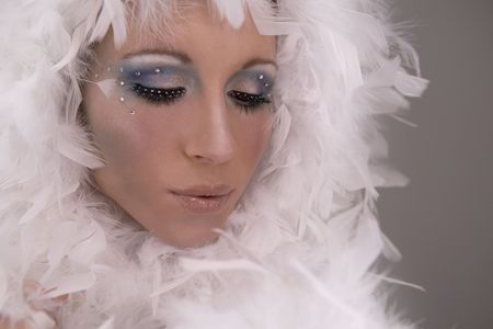 stunning blond model wearing white boa and dark makeupの写真素材