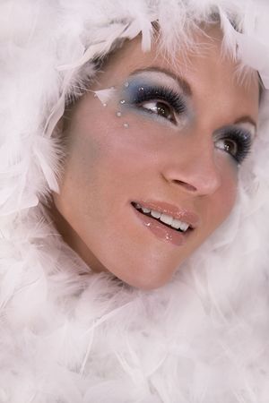 stunning blond model wearing white boa and dark makeupの写真素材