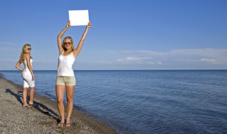 sisters holding white sign in the summer dayの写真素材