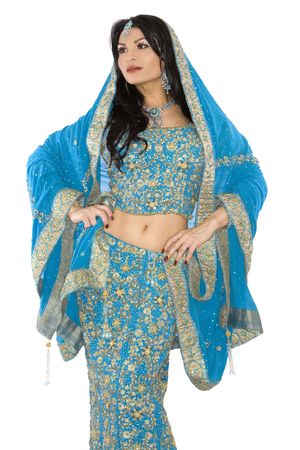 pretty brunette wearing traditional indian outfit on whiteの写真素材