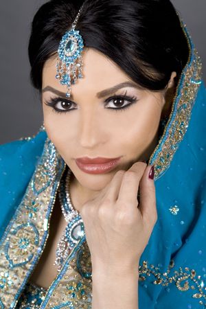 pretty brunette wearing traditional indian outfit on whiteの写真素材