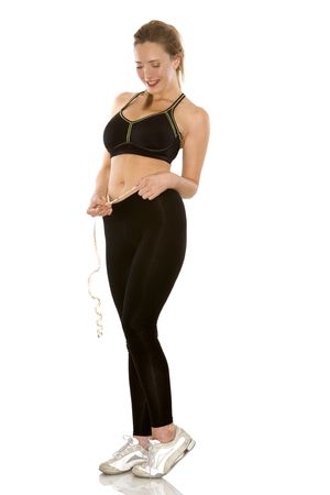 pretty redhead wearing sport outfit on white backgroundの写真素材