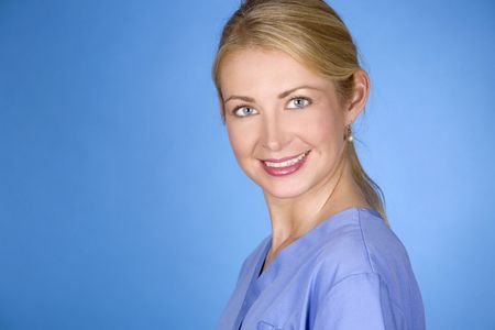 beautiful blond healthcare worker wearing blue uniform scrubsの写真素材