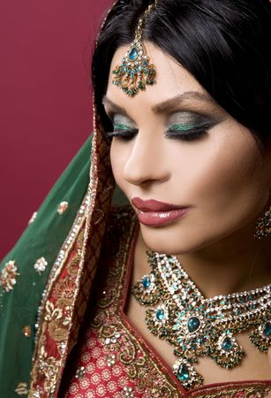 beautiful indian woman wearing bridal outfit on whiteの写真素材