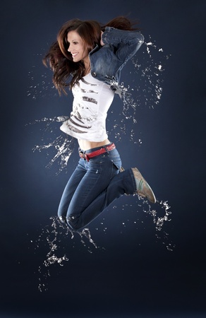 beautiful dancer having fun on dark backgroundの写真素材