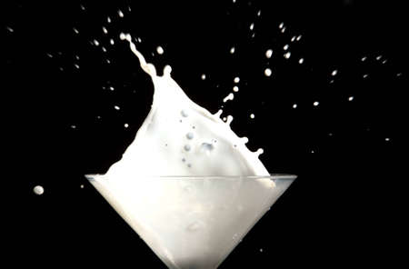 white milk splash on black backgroundの写真素材
