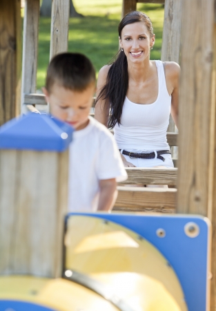 young mother playing with her son in the parkの写真素材