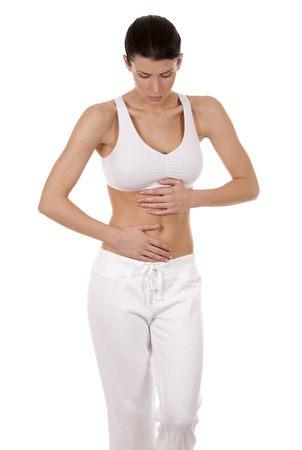 brunette holding her belly on white isolated backgroundの写真素材