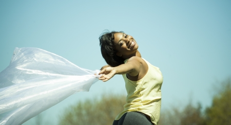 pretty black woman enjoying summer in the parkの写真素材