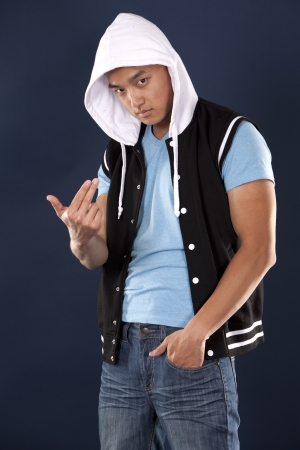 casual man wearing blue tshirt and jeans on dark backgroundの写真素材