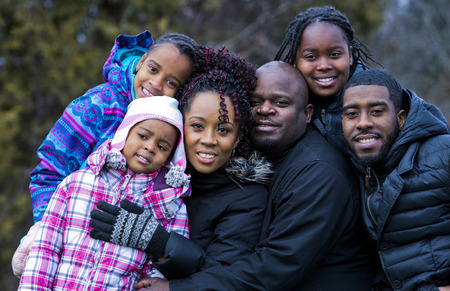 casual winter young black family outdoors in the parkの写真素材