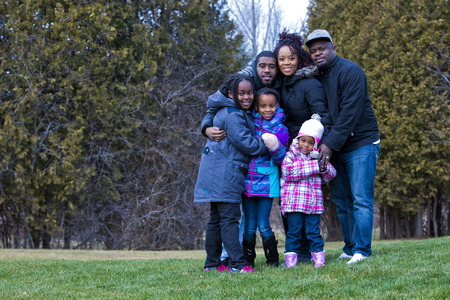 casual winter young black family outdoors in the parkの写真素材