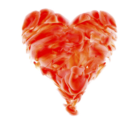 red liquid paint in shape of heart on white backgroundの写真素材