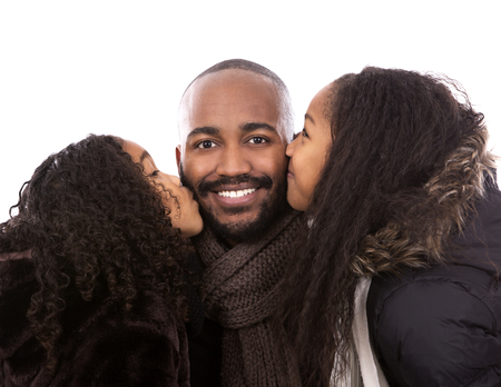 father with daughters in winter jackets on white isolated backgroundの写真素材
